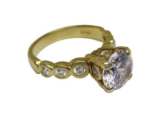 R-193MD 
“Candy” Ring Mounting, 18K yellow gold, Cubic Zirconia center stone (center fits a 8.5-9.5mm  round stone), 10 accent diamonds totaling 0.42ct. 
Available for immediate delivery in size 5 ¾. 
$4,180.00 (Note center stone is not a diamond!)

