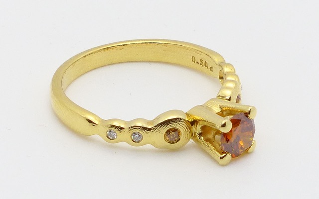 R-196DC
“Flora” natural color diamond ring, 18K yellow gold, with a 0.50 ct natural colored diamond center (GIA certified), 4 white diamonds of 0.03 ct total and 2 natural colored diamonds of 0.04 ct total. Available for immediate delivery in finger size 6 ¾ 
$8,295
