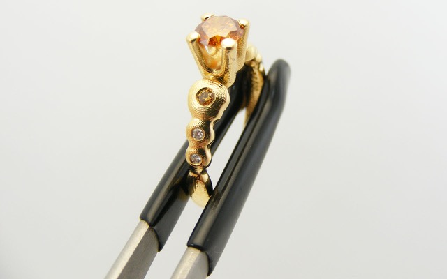 R-196DC
“Flora” natural color diamond ring, 18K yellow gold, with a 0.50 ct natural colored diamond center (GIA certified), 4 white diamonds of 0.03 ct total and 2 natural colored diamonds of 0.04 ct total. Available for immediate delivery in finger size 6 ¾ 
$8,295
