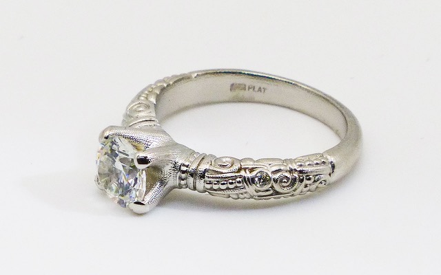 R-56PM
Platinum Cubic Zirconia and diamond ring, CZ center stone (fits a 6.5-7.5mm round stone), 1 accent diamond totaling 0.015 ct.
Immediately available in size 7 3/4					
$3940
