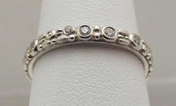 R117P
“Mini 62”, Platinum, .23 ctw diamonds, 2.5mm wide, in store in size 6 1/4
$3,340
