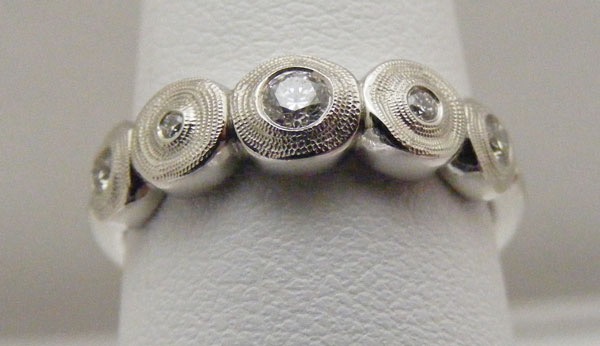 R210PD
“Five Seeds”, Platinum & diamond ring, (5 diamonds = .20 ctw), in store in size 6 ¼
$3,005
